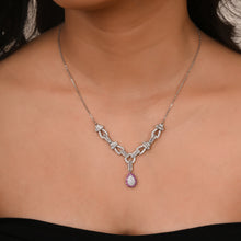 silver necklace set on a models's neck