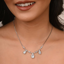 silver necklace set close up worn by a model